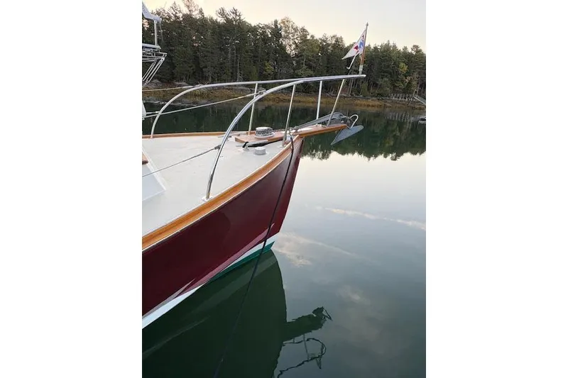 Slide: The Image of Bow of a 2005 John Williams Custom 38 boat on calm water. - 20