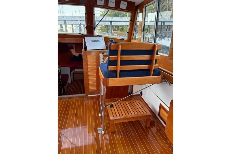 Slide: The Image of Interior of 2005 John Williams Custom 38 boat with wooden helm and seating. - 4