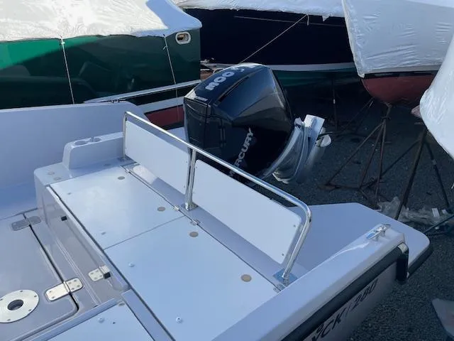 Slide: The Image of 2024 RYCK 280 boat with Mercury outboard motor, docked and covered. - 7