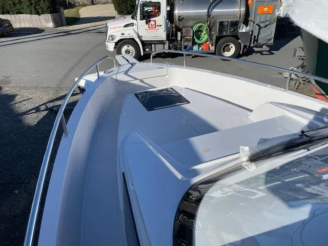 Slide: The Image of 2024 RYCK 280 boat deck with railing, parked near utility truck. - 9