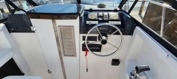 Slide: The Image of 1994 Bayliner Trophy boat cockpit with steering wheel and control panel. - 4