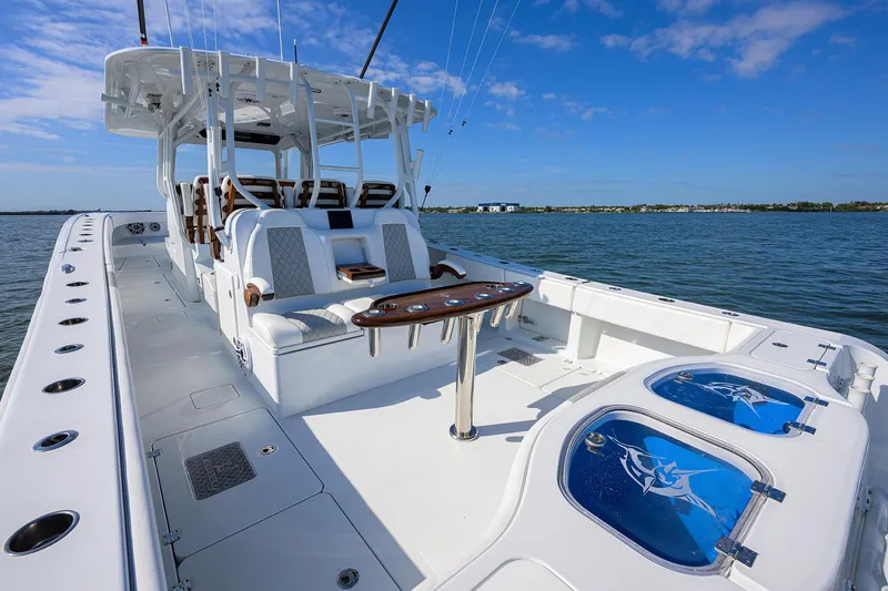 Slide: The Image of 2022 Freeman Center Console boat on open water with fishing amenities. - 14