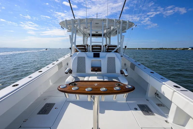 Slide: The Image of 2022 Freeman Center Console boat on open water, featuring spacious deck and modern seating. - 16