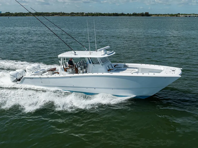 Slide: The Image of 2022 Freeman Center Console boat cruising on open water. - 2