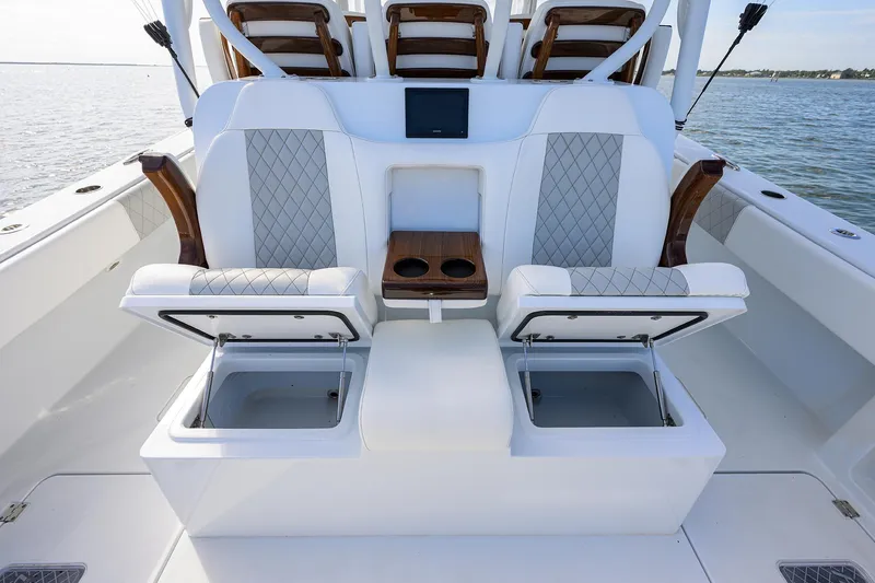 Slide: The Image of 2022 Freeman Center Console boat interior with open storage compartments and cushioned seats. - 20