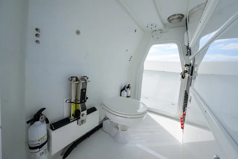 Slide: The Image of 2022 Freeman Center Console boat interior with toilet and safety equipment. - 24