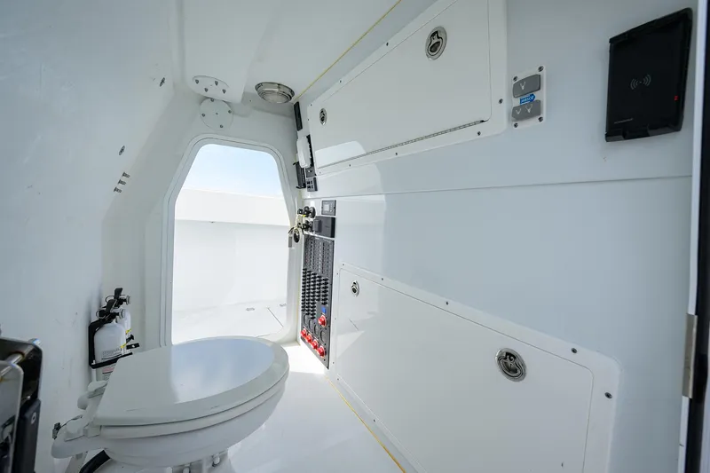 Slide: The Image of 2022 Freeman Center Console boat interior with storage compartments and toilet. - 25