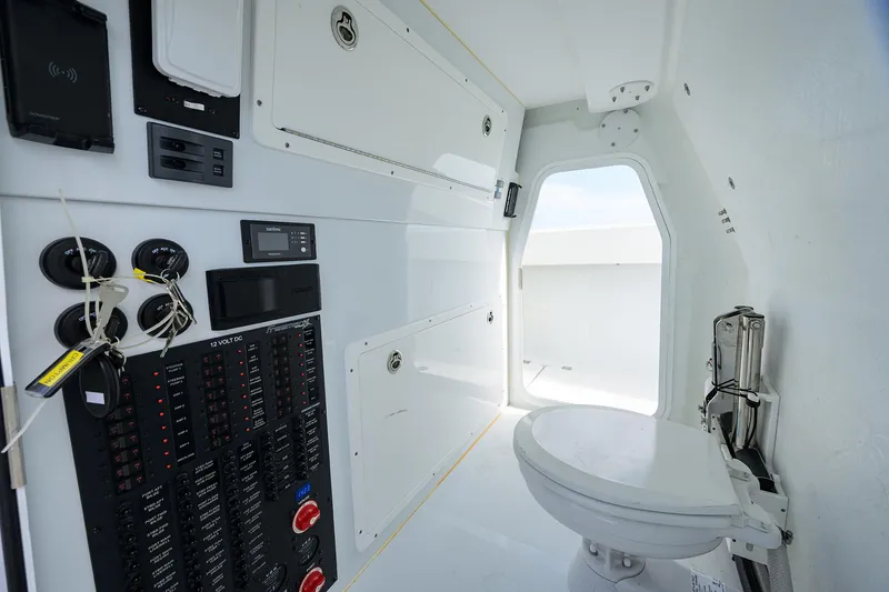 Slide: The Image of Interior of 2022 Freeman Center Console boat with control panel and marine toilet. - 26