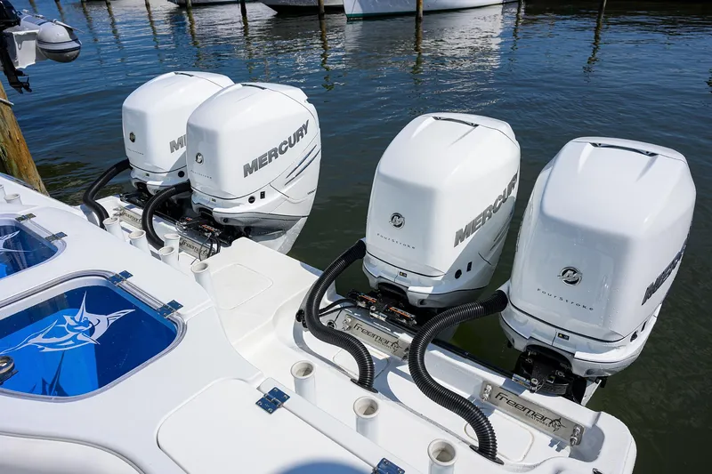 Slide: The Image of 2022 Freeman Center Console boat with four Mercury outboard engines docked in marina. - 27