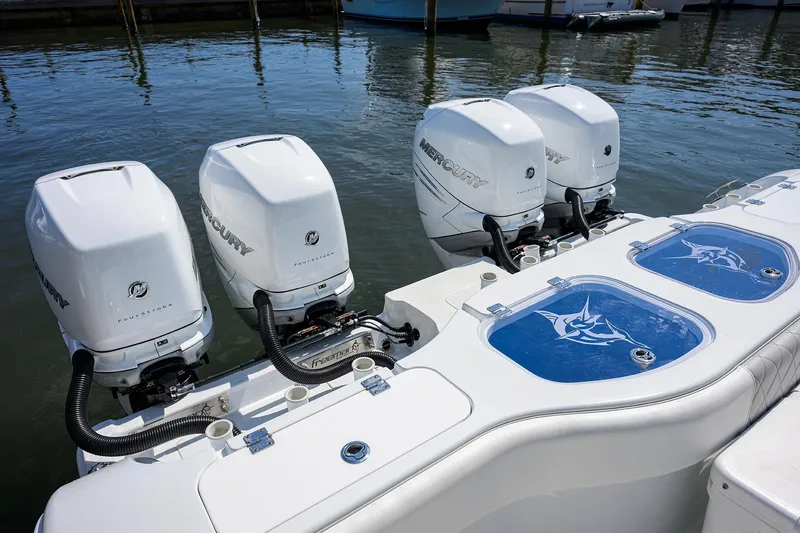 Slide: The Image of 2022 Freeman Center Console boat with four Mercury outboard engines. - 28