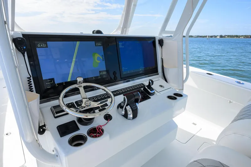 Slide: The Image of 2022 Freeman Center Console boat dashboard with dual navigation screens and steering wheel. - 30