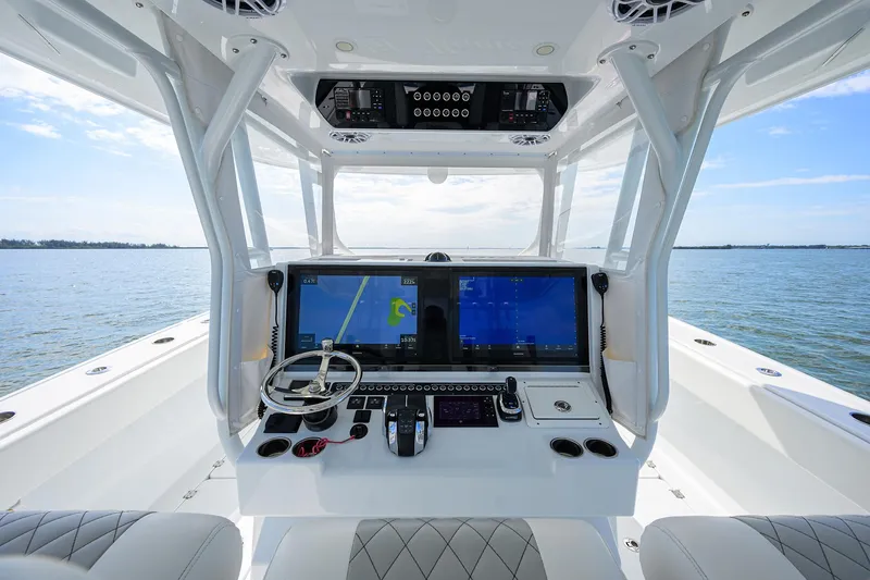 Slide: The Image of 2022 Freeman Center Console boat with advanced navigation system on open water. - 32