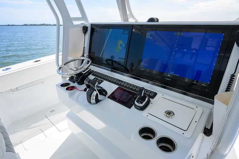 Slide: The Image of 2022 Freeman Center Console boat dashboard with dual screens and steering wheel. - 33