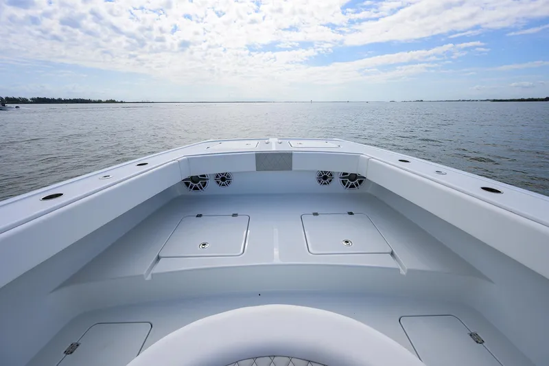 Slide: The Image of 2022 Freeman Center Console boat on open water under a partly cloudy sky. - 4