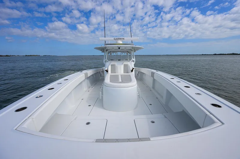 Slide: The Image of 2022 Freeman Center Console boat on open water under a partly cloudy sky. - 9