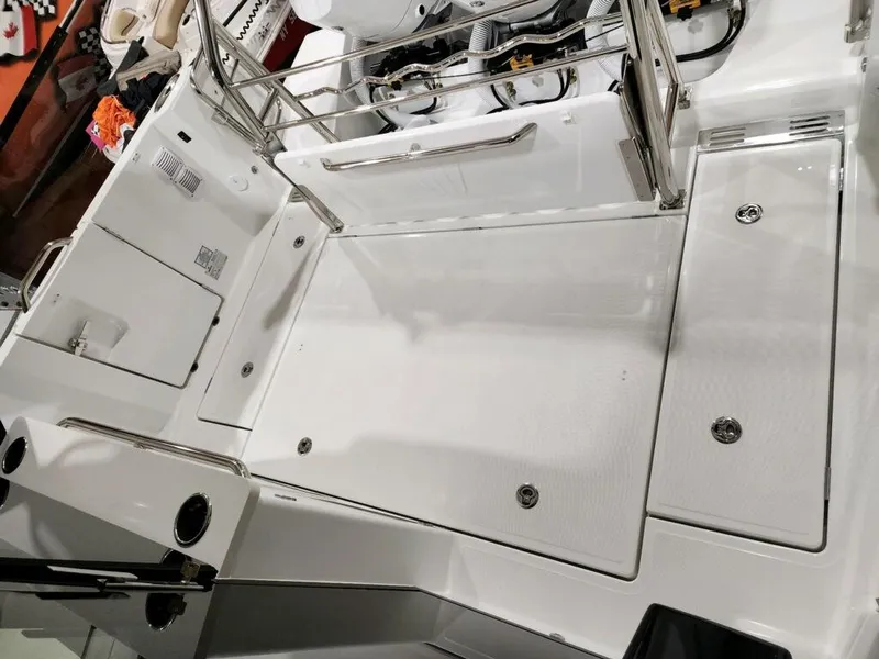 Slide: The Image of 2024 Wellcraft 355 Commuter boat deck with stainless steel railings and storage compartments. - 11