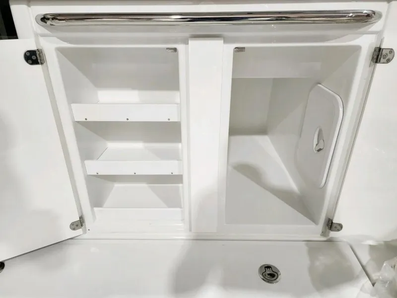 Slide: The Image of 2024 Wellcraft 355 Commuter storage compartments with shelves and hatch. - 15