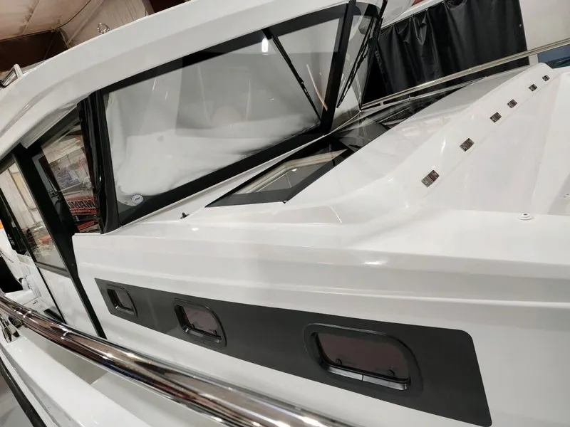 Slide: The Image of 2024 Wellcraft 355 Commuter boat exterior with sleek design and modern windows. - 17