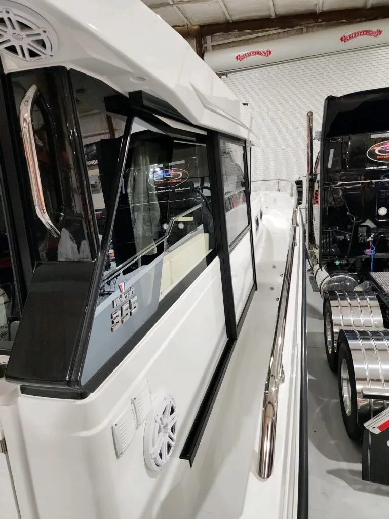 Slide: The Image of 2024 Wellcraft 355 Commuter boat side view in a showroom. - 23