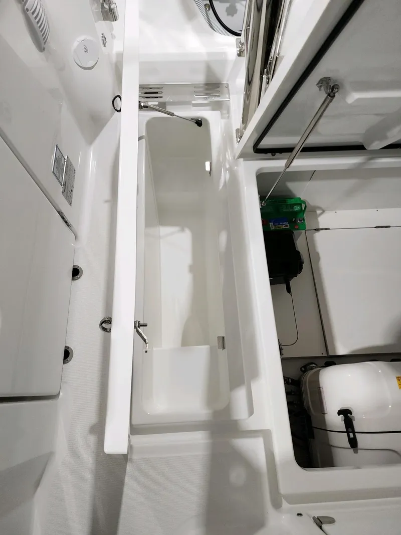 Slide: The Image of 2024 Wellcraft 355 Commuter boat interior showing storage compartments and equipment. - 4
