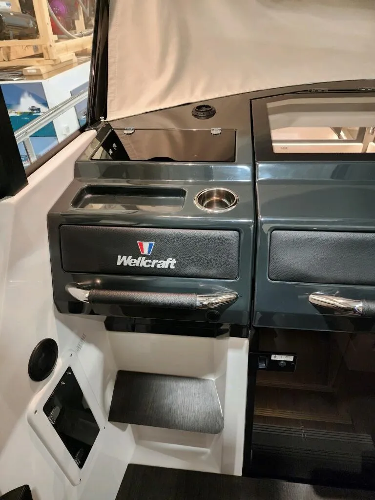 Slide: The Image of 2024 Wellcraft 355 Commuter boat interior with sleek dashboard and storage compartments. - 40