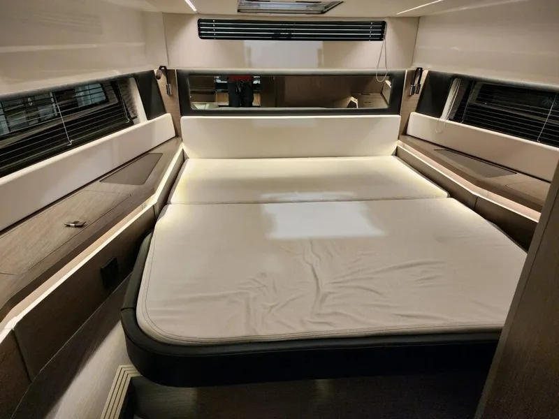 Slide: The Image of 2024 Wellcraft 355 Commuter cabin interior with a spacious bed and modern design. - 44