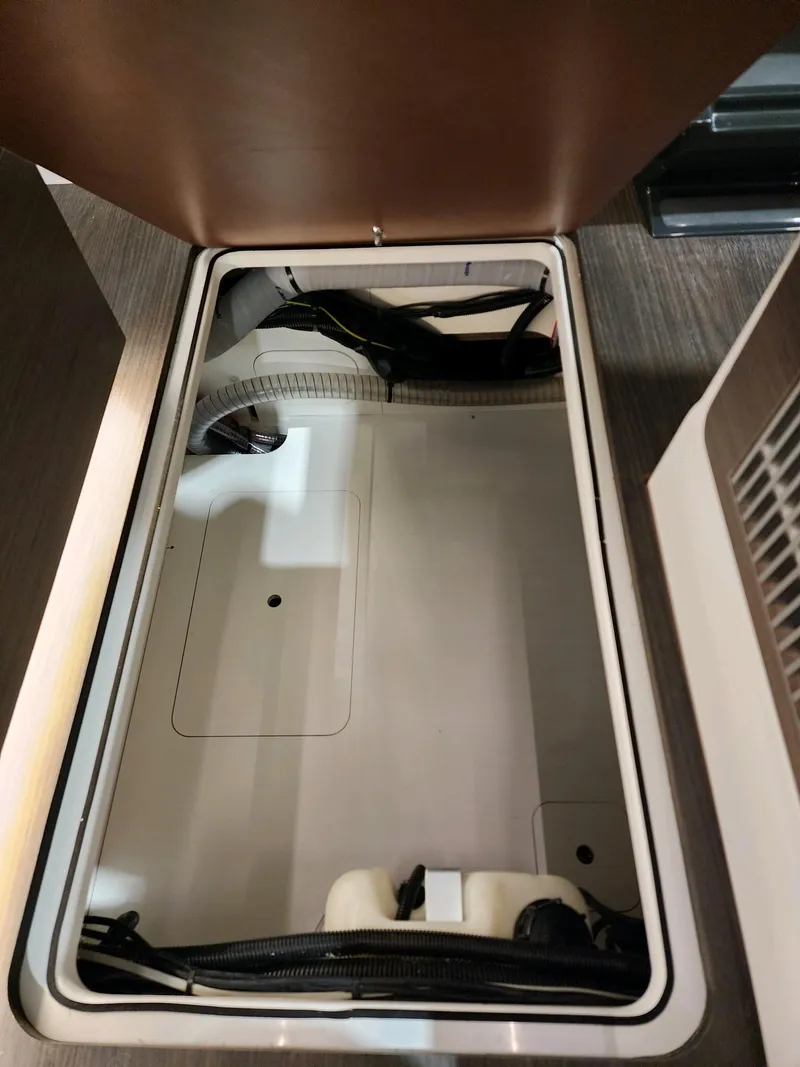 Slide: The Image of 2024 Wellcraft 355 Commuter storage compartment with open hatch. - 5