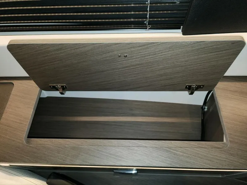 Slide: The Image of Open storage compartment in 2024 Wellcraft 355 Commuter boat interior. - 51