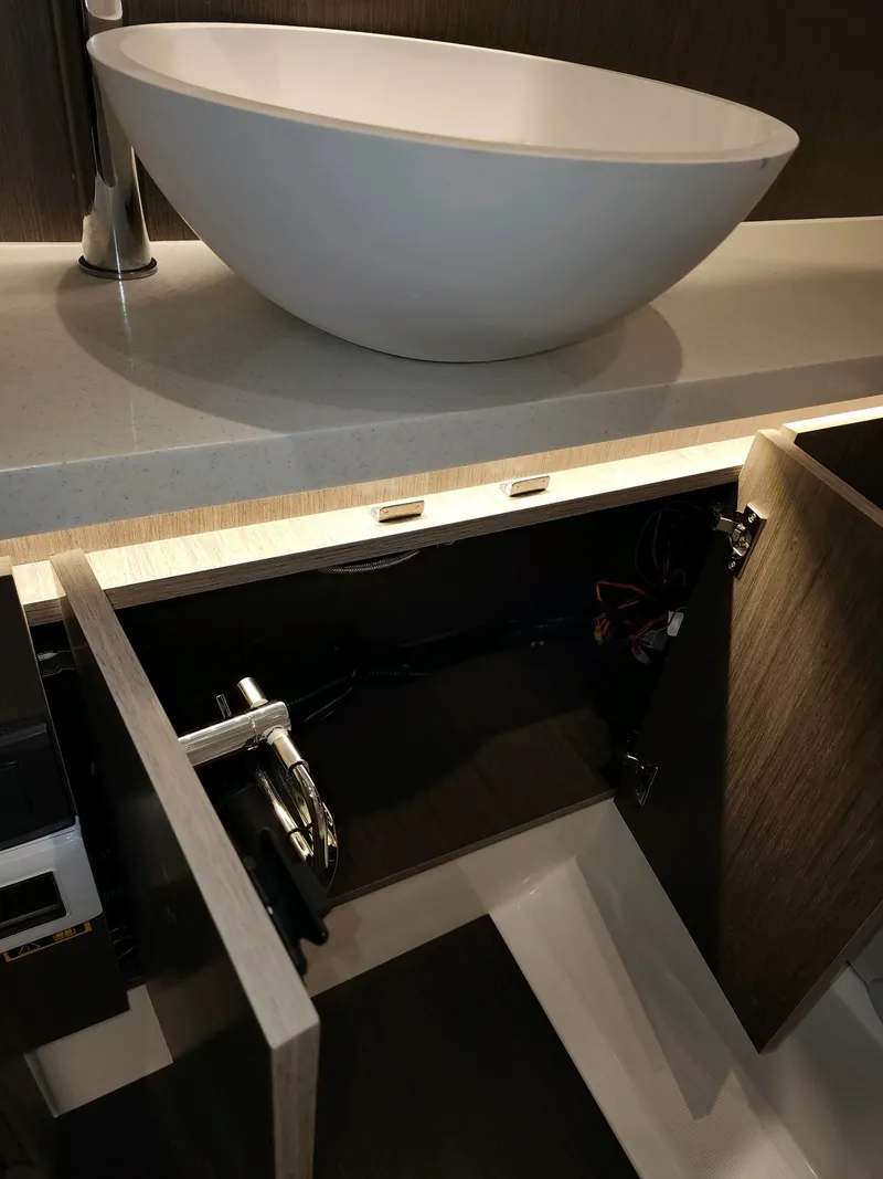 Slide: The Image of Modern sink and open cabinet in 2024 Wellcraft 355 Commuter boat. - 7