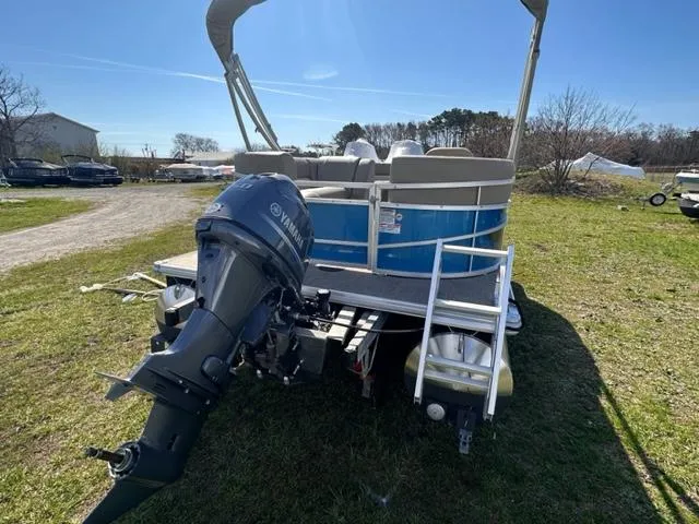 Slide: The Image of 2023 Starcraft LX 18 R pontoon boat with Yamaha outboard motor. - 2