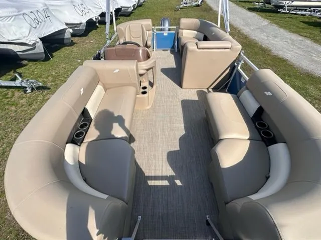 Slide: The Image of 2023 Starcraft LX 18 R pontoon boat interior with beige seating and cup holders. - 3