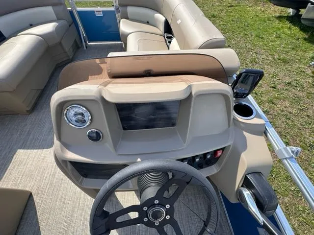 Slide: The Image of 2023 Starcraft LX 18 R boat interior with steering wheel and seating. - 5