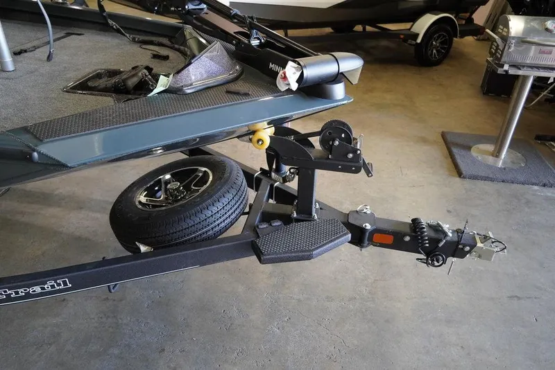 Slide: The Image of 2024 Ranger RT198P boat trailer hitch and spare tire in a garage. - 10