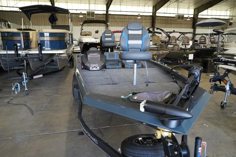 Slide: The Image of 2024 Ranger RT198P fishing boat in showroom, featuring dual seats and spacious deck. - 8