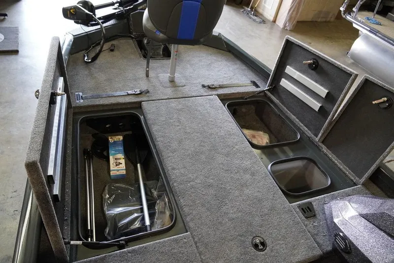 Slide: The Image of 2024 Ranger RT198P boat interior with open storage compartments and seating. - 9