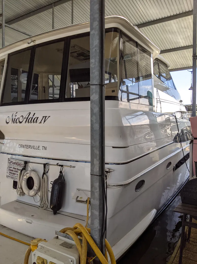 Slide: The Image of 2000 Carver 506 Motor Yacht docked in a covered marina. - 1