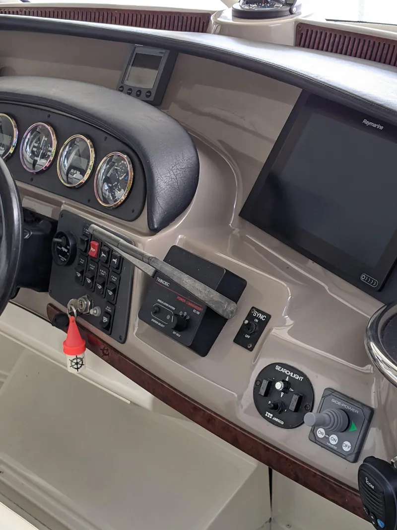 Slide: The Image of Dashboard of a 2000 Carver 506 Motor Yacht with gauges and navigation equipment. - 13