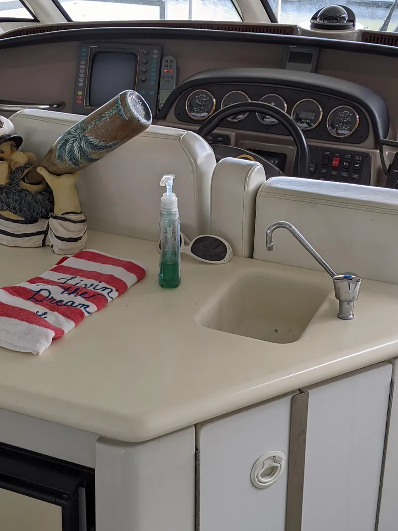 Slide: The Image of Carver 506 Motor Yacht 2000 helm with sink, decor, and navigation instruments. - 17