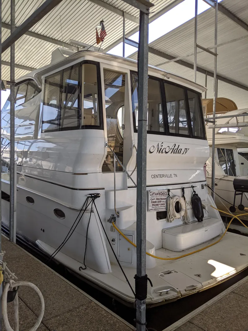 Slide: The Image of 2000 Carver 506 Motor Yacht docked in a covered marina. - 2