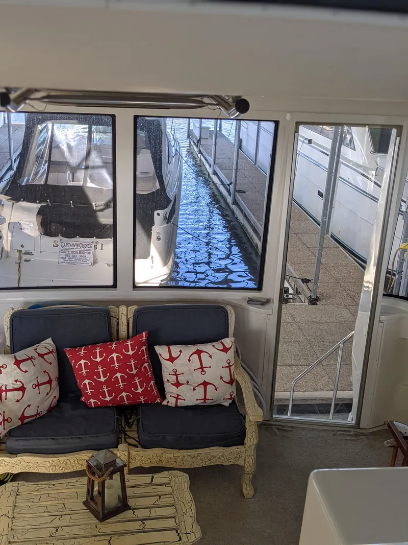 Slide: The Image of Interior of 2000 Carver 506 Motor Yacht with nautical-themed cushions and marina view. - 23
