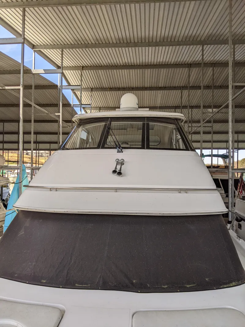 Slide: The Image of Front view of a 2000 Carver 506 Motor Yacht docked in a covered marina. - 3