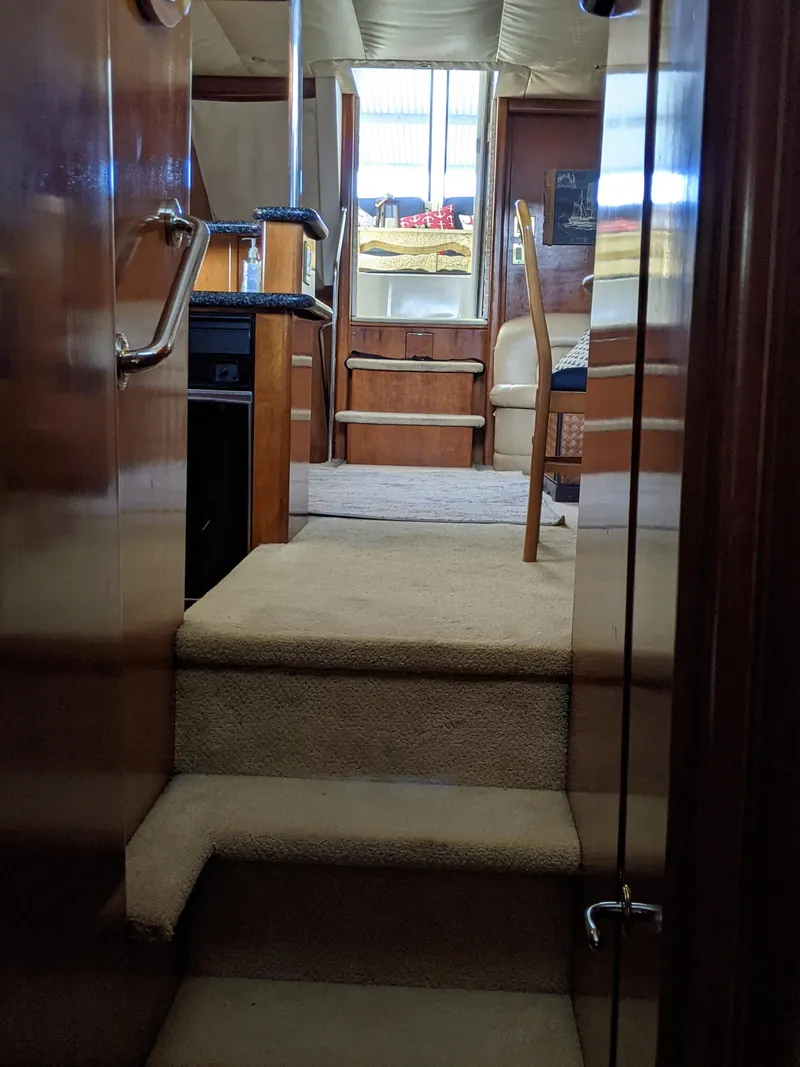 Slide: The Image of Interior view of 2000 Carver 506 Motor Yacht with carpeted stairs and wooden finishes. - 31