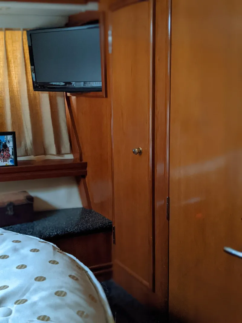 Slide: The Image of Interior cabin of 2000 Carver 506 Motor Yacht with TV and wooden cabinetry. - 37