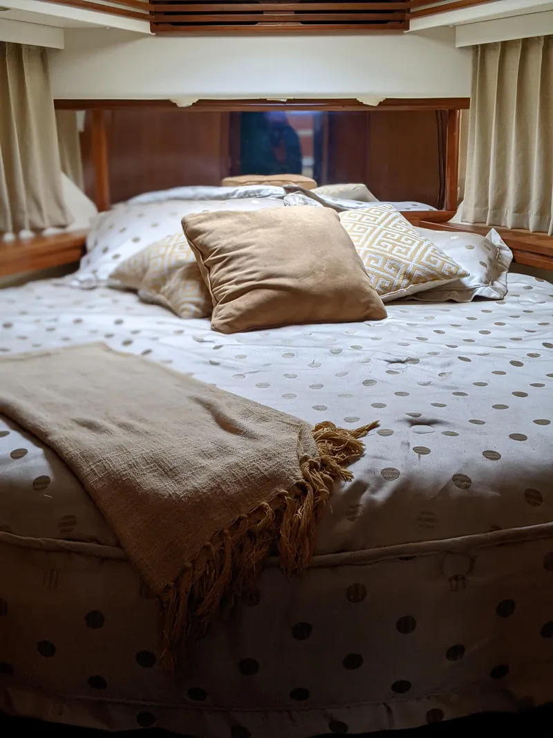 Slide: The Image of Cozy bedroom in a 2000 Carver 506 Motor Yacht with plush pillows and blanket. - 39