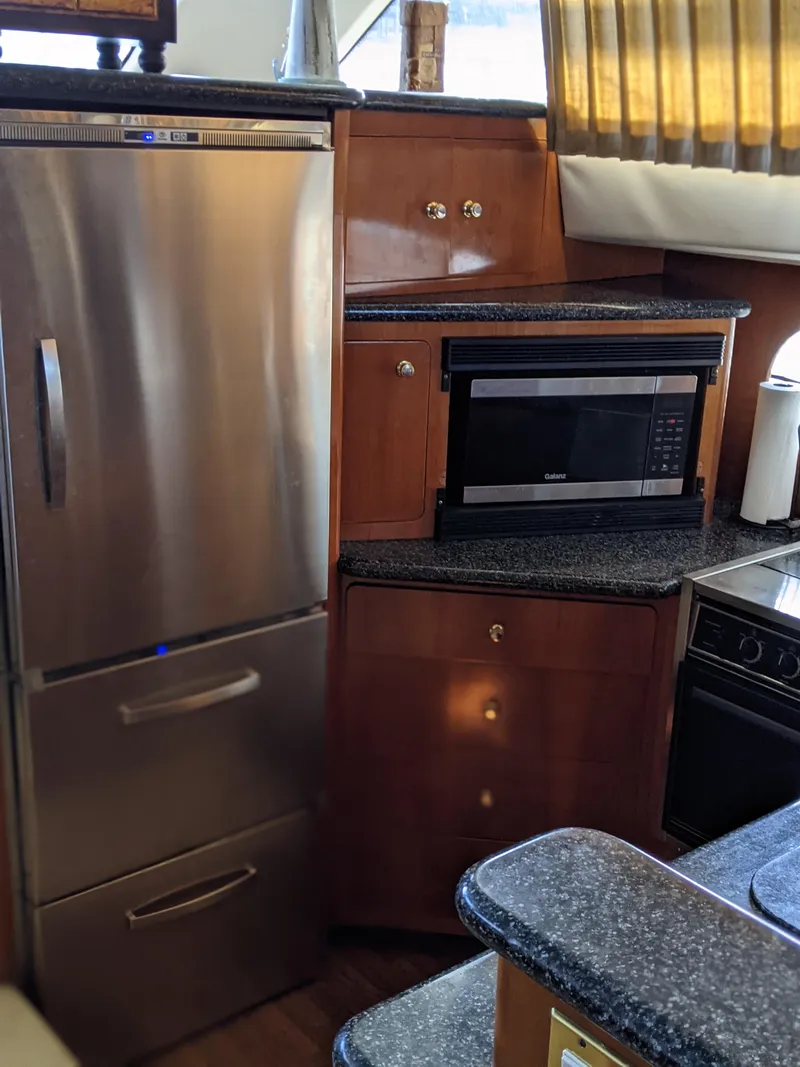 Slide: The Image of 2000 Carver 506 Motor Yacht kitchen with stainless steel appliances and microwave. - 42