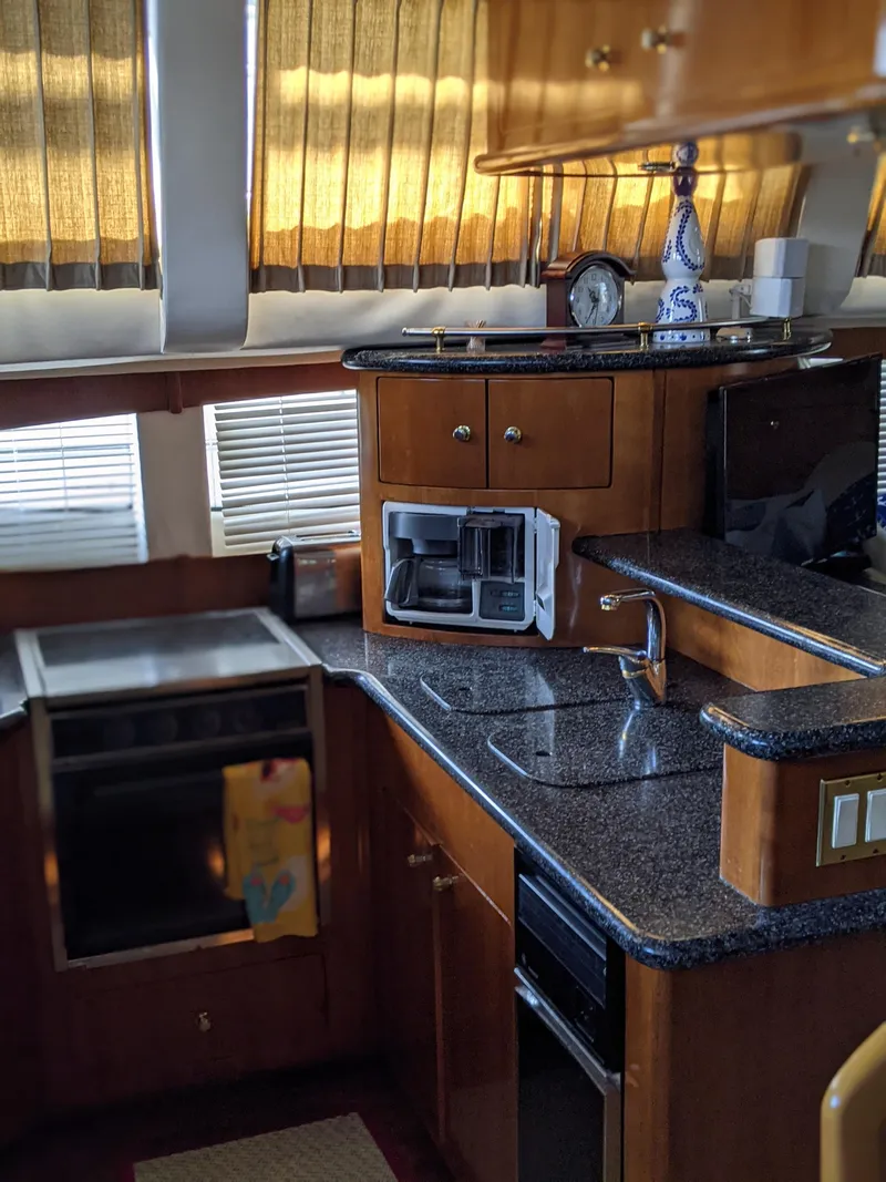 Slide: The Image of Interior kitchen of 2000 Carver 506 Motor Yacht with modern appliances and wooden cabinetry. - 44