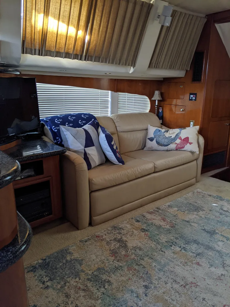 Slide: The Image of Interior of 2000 Carver 506 Motor Yacht with beige leather sofa and nautical-themed pillows. - 45