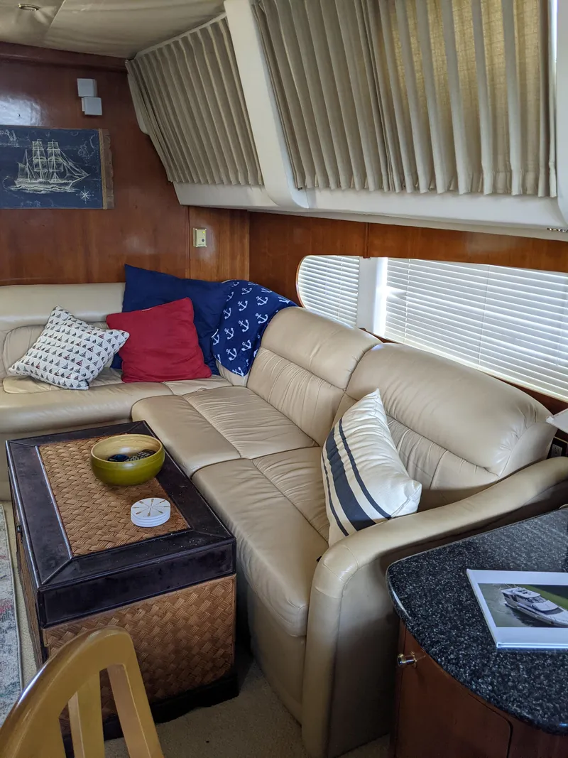 Slide: The Image of Interior of 2000 Carver 506 Motor Yacht with beige leather seating and nautical decor. - 46