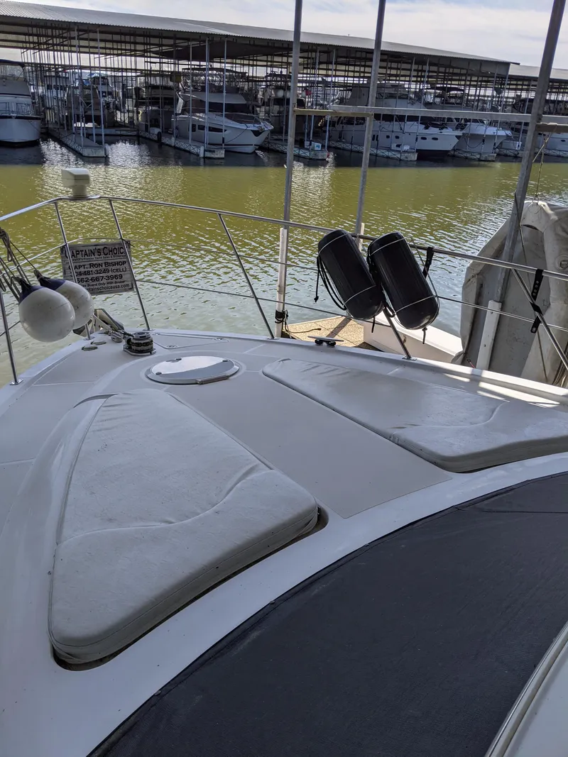 Slide: The Image of 2000 Carver 506 Motor Yacht docked at a marina. - 6
