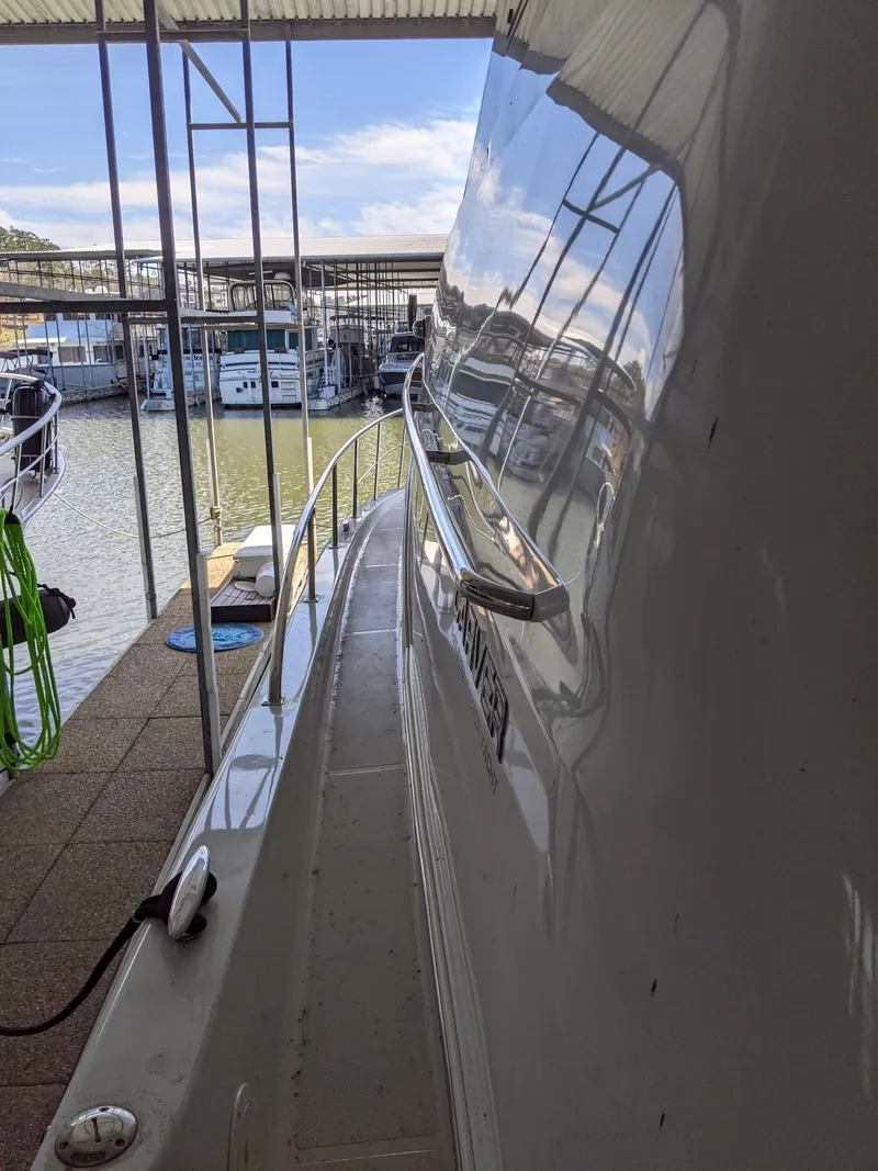 Slide: The Image of Side view of a 2000 Carver 506 Motor Yacht docked at a marina. - 7